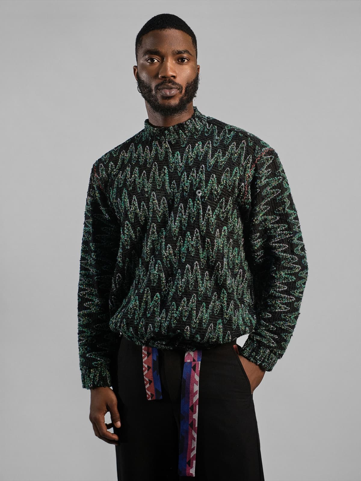 Green and black chevron-pattern overshirt with a band collar and a woven belt.