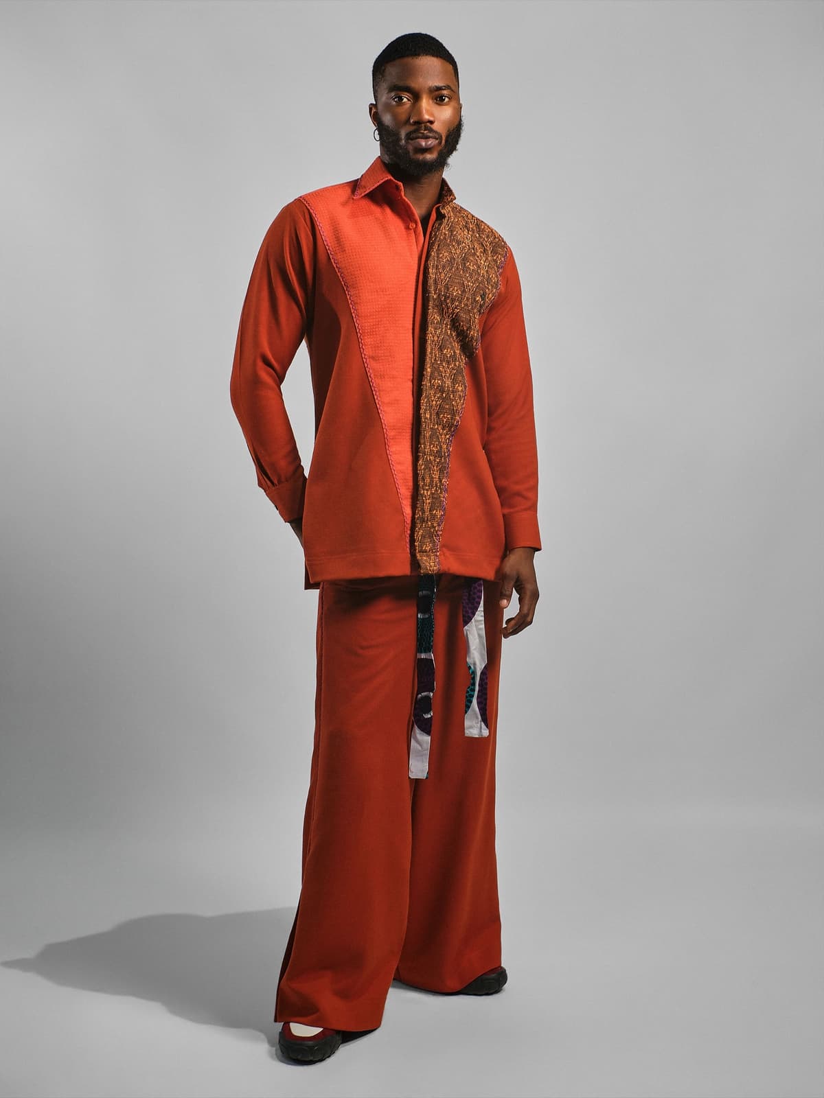 Rust shirt with a gold-patterned panel down the left side, matching rust wide trousers.